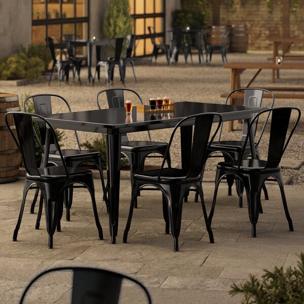 A Lancaster Table & Seating black table with six chairs on an outdoor patio.