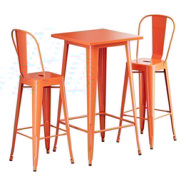 An amber orange metal table with two barstools.