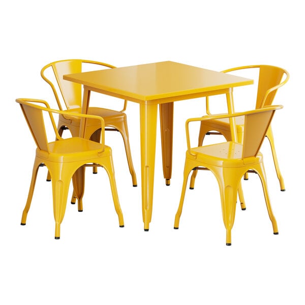 A Lancaster Table & Seating citrine yellow metal table and chairs set on an outdoor patio.