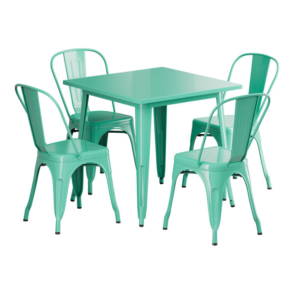 A Lancaster Table & Seating outdoor table in aquamarine with four chairs around it.