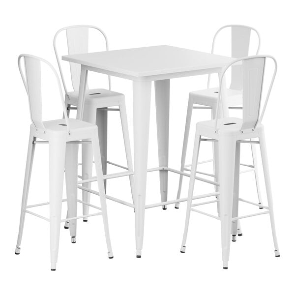 A Lancaster Table & Seating pearl white metal bar table surrounded by four white barstools.