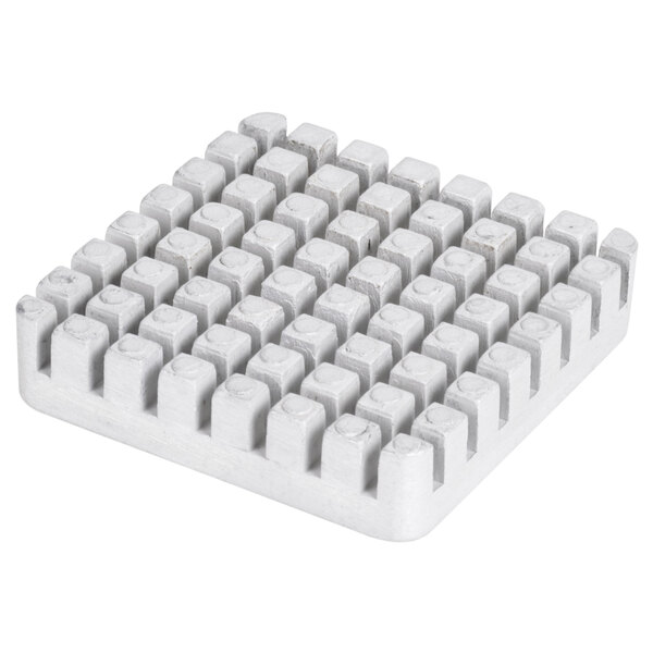 A white square Vollrath push block with many small squares on it.