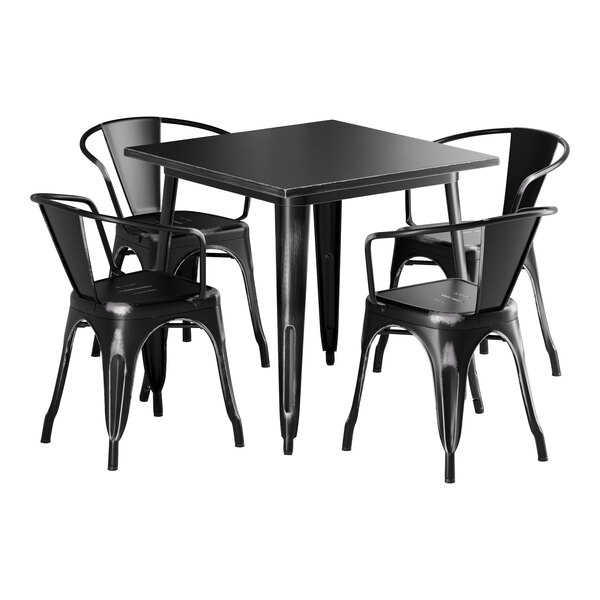 A Lancaster Table & Seating black metal table with four black chairs.