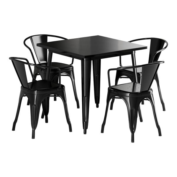 A Lancaster Table & Seating Onyx Black metal table with four black chairs.