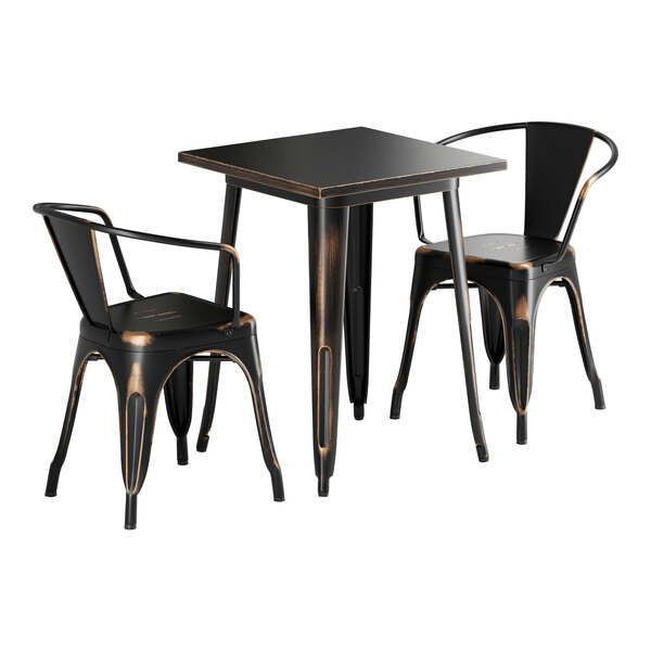 A black square Lancaster Table & Seating outdoor table with brown edges and two black metal chairs.