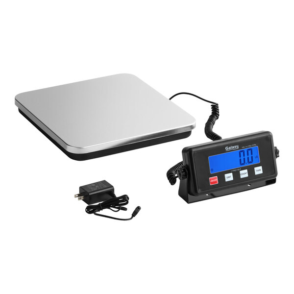 A low-profile digital receiving scale with a remote display and power adapter.