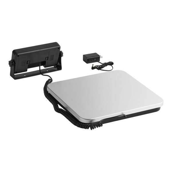 A low-profile digital receiving scale with a remote display and power adapter.