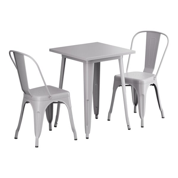 A nickel gray square table with two chairs.