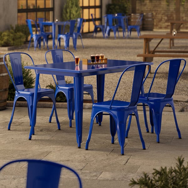 A blue Lancaster Table & Seating outdoor table with chairs set.