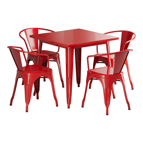 A Lancaster Table & Seating ruby red outdoor table with four red chairs around it.