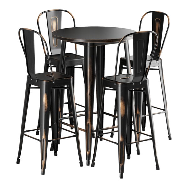A Lancaster Table & Seating distressed copper bar height table with four black metal chairs.
