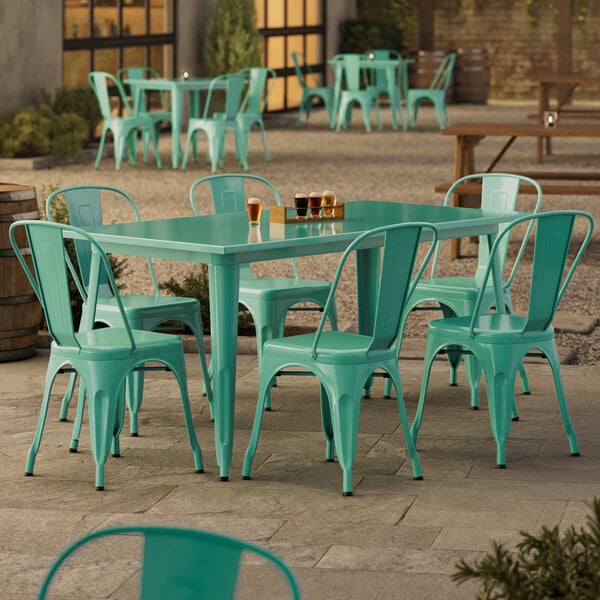 An aquamarine table with chairs on an outdoor patio.