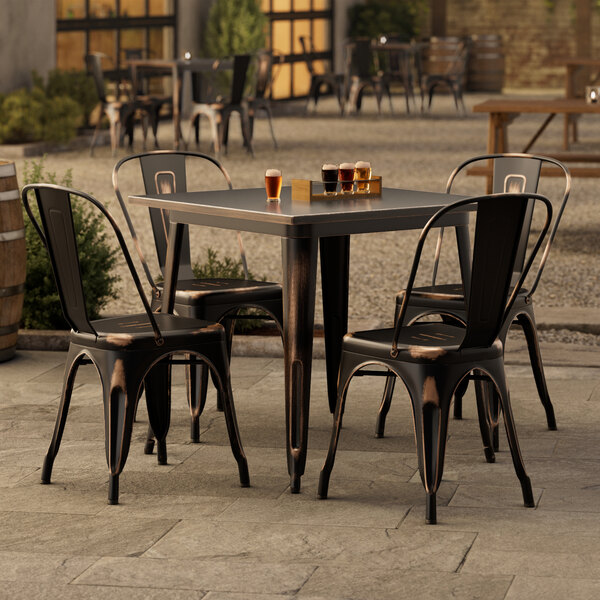 A Lancaster Table & Seating outdoor table and chairs on a patio.