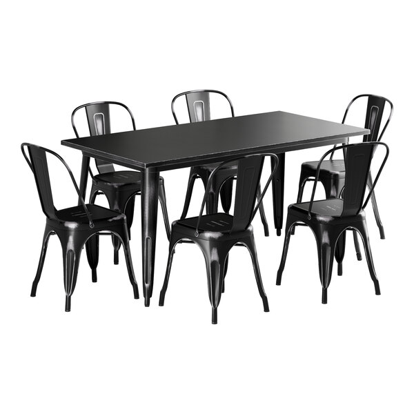 A black rectangular Lancaster Table & Seating outdoor table with a black distressed finish next to six black chairs.