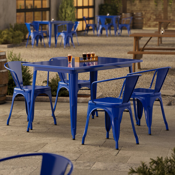 A blue table and chairs on a patio.