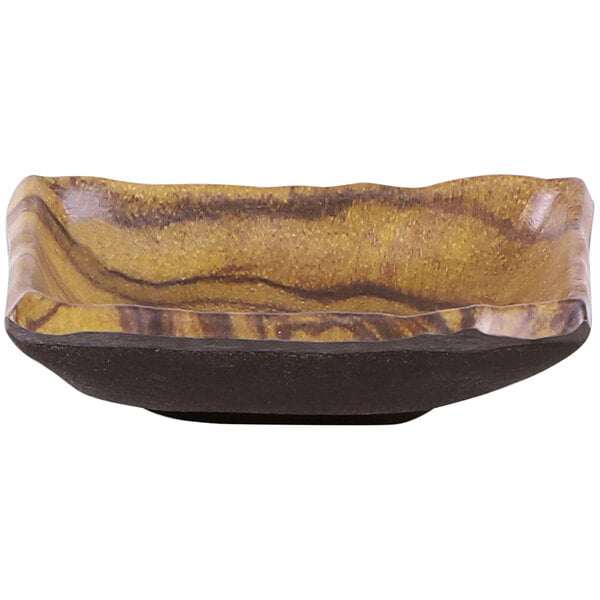 A brown and black Elite Global Solutions wood grain melamine sauce dish.