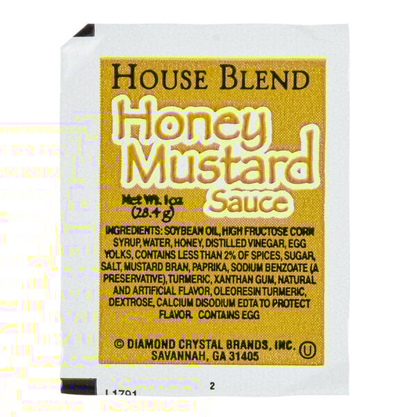 A yellow and black labeled portion cup of honey mustard sauce.