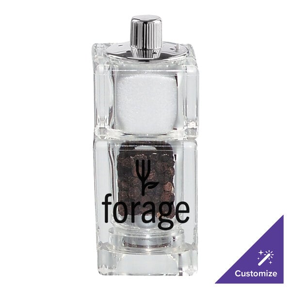 A Chef Specialties cubic acrylic salt and pepper shaker with a lid containing black pepper.
