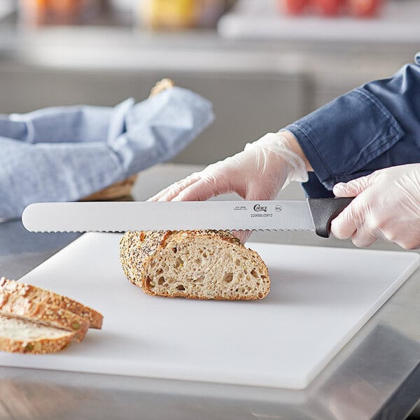 a knife being held over a piece of bread