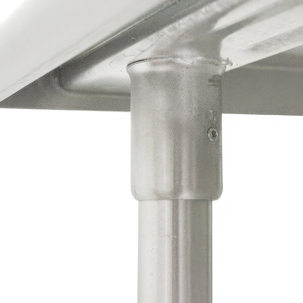A close-up of a metal pipe used as a table leg.