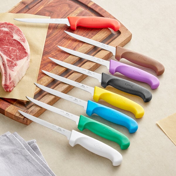 Choice 6" Narrow Stiff Boning Knife with Green Handle and a group of knives with different colored handles