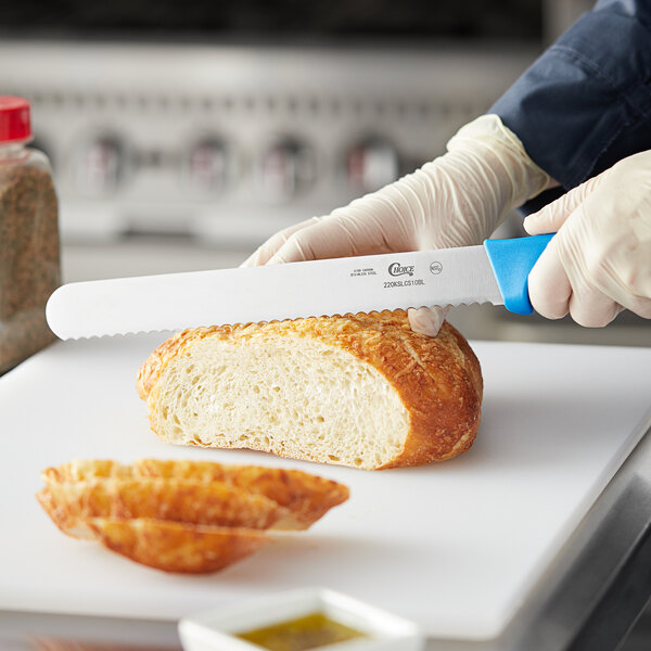A person cutting bread with a Choice serrated bread knife.