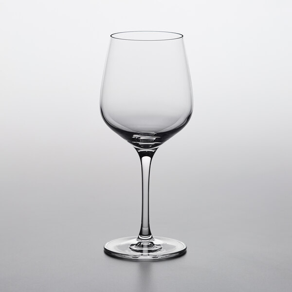 A close up of a Nude Refine white wine glass on a white surface.