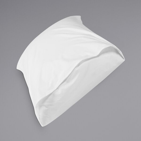 A white Protect-A-Bed pillow on a bed.