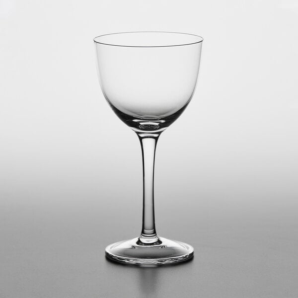 A case of 12 Nude Refine Nick and Nora glasses on a table.