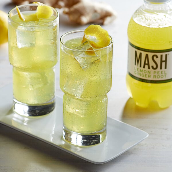 Two glasses of Boylan Mash Lemon Peel Ginger Root Sparkling Fruit Beverage on a table with lemon slices.