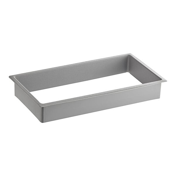 A gray metal rectangular Assure collar on a counter.