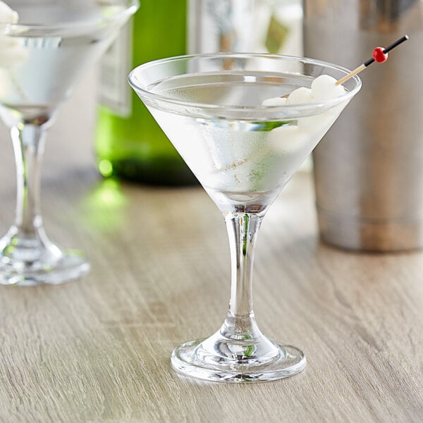 Two Pasabahce martini glasses with drinks in them.