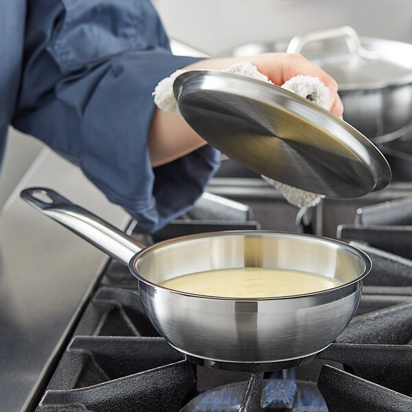 Stainless steel-clad bottom saucepan simmering bechamel sauce