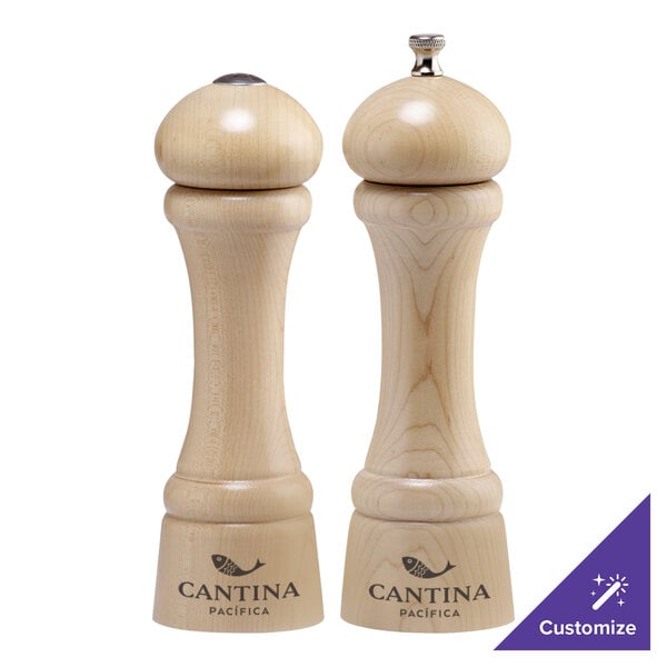 Two Chef Specialties Windsor Natural Maple pepper mills on a counter.