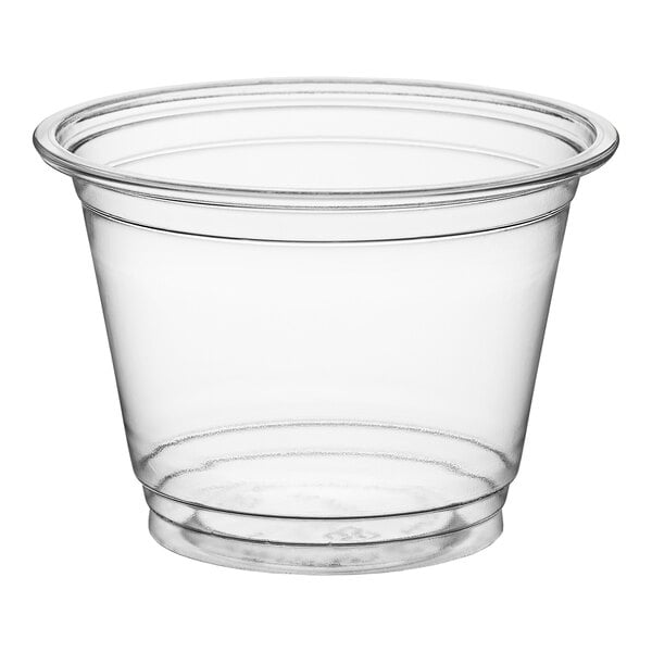 A clear, squat plastic cup with a wide rim and slightly tapered sides.