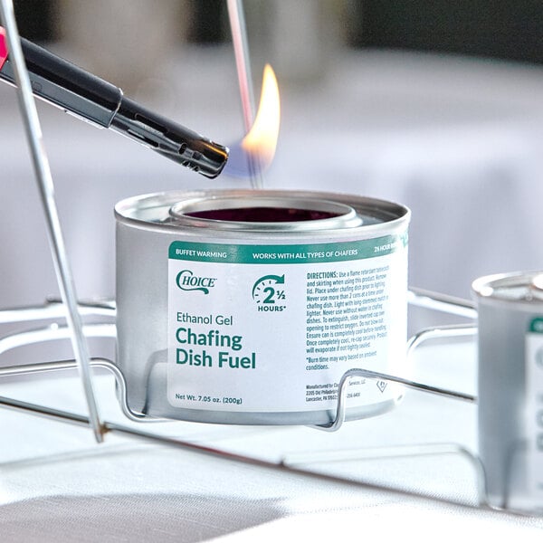 A can of Choice 2.5 Hour Ethanol Gel Chafing Dish Fuel being lit with a lighter.
