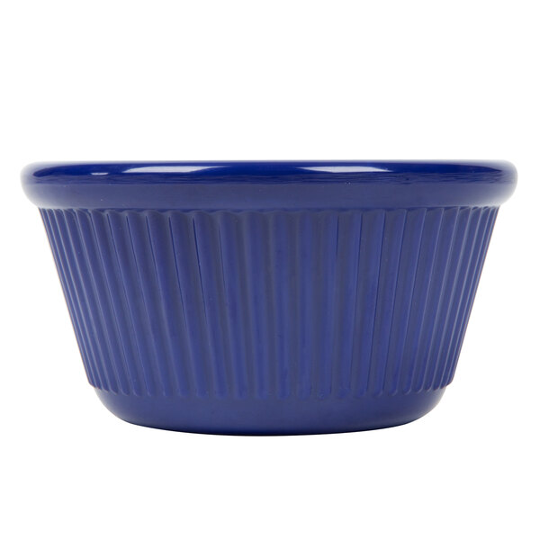 A close-up of a navy blue fluted melamine ramekin.