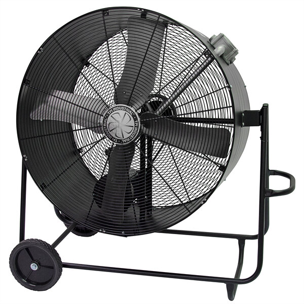 A large black TPI industrial drum fan on wheels.