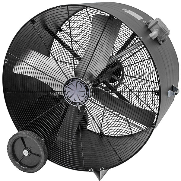 A large black TPI industrial drum fan with wheels.