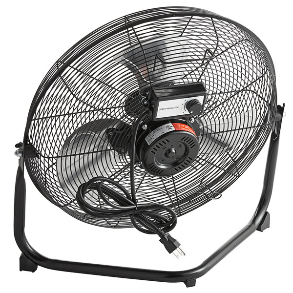 A black TPI industrial floor fan with a cord.