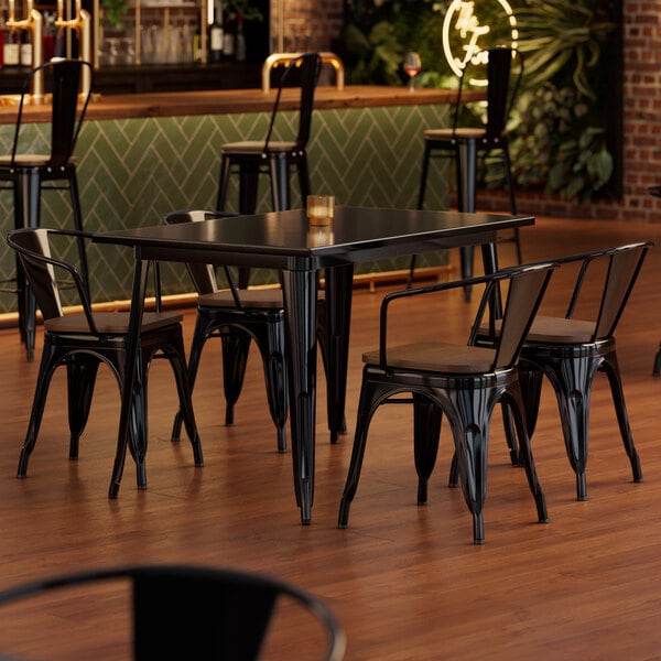 A Lancaster Table and 4 Arm Chairs with Walnut Wood Seats on a Lancaster Table and Seating Onyx Black Table.