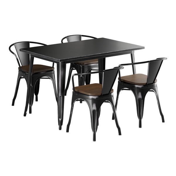 A Lancaster Table & Seating black metal table with walnut wood seats and metal pole chairs.