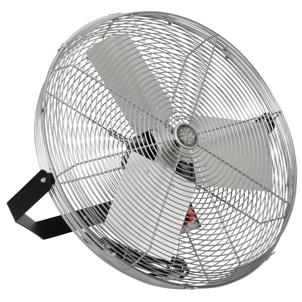 A close-up of a TPI industrial wall-mount fan with a metal tilt head.