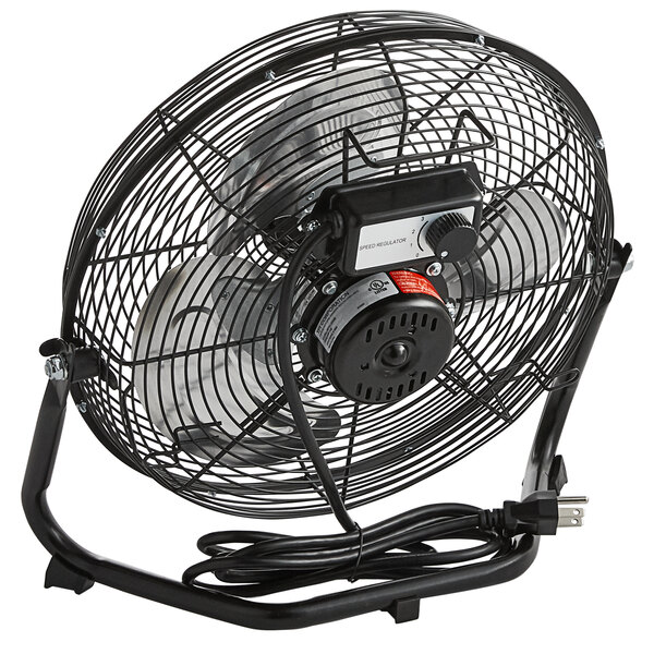A TPI 12" industrial floor fan with a metal stand and black cord.