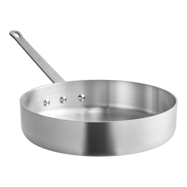 A stainless steel saute pan with a long handle and a flat base.