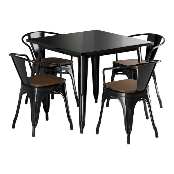 A black square Lancaster Table & Seating table with black metal chairs with walnut wood seats.