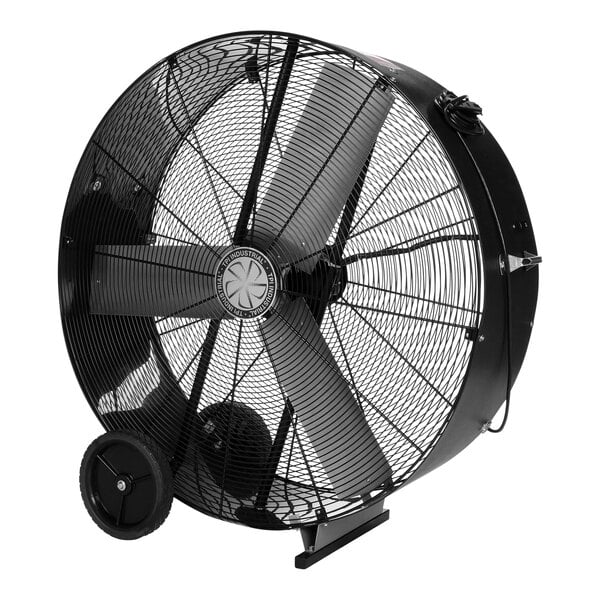 A large black TPI industrial drum fan with wheels.