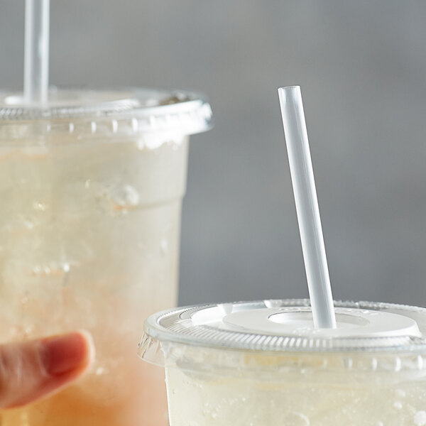 Two cups with Choice jumbo straws in them.