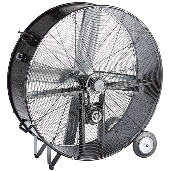 A large black TPI industrial fan on wheels.