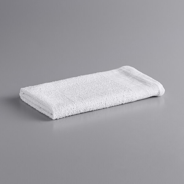 Monarch Brands white terry cloth rag on a gray surface.